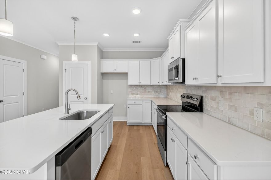 NO RENTAL RESTRICTIONS!!! Our stunning pool is NOW OPEN! The prefect place to SOAK UP THAT Florida SUN! Seagate at Clara is a new townhome community nestled in the vibrant city of Panama City Beach, FL. This two-story unit features board and batten exterior and covered entries. One car garage provides a great space for storing beach essentials. This open concept townhome boasts a stylish kitchen with white cabinets, tile backsplash, a large island with quartz counter tops - perfect for entertaining.  The elegant Owners Suite is designed with comfort in mind showcasing a large walk in closet and double- bowl vanities. Main Bath has tiled shower.  All bathrooms have quartz countertops.  LVP is located throughout the home.  The community pool features a cabana, lounging, seating and grilling stations. This community has a dedicated dog park. Seagate at Clara is in a prime location, approximately 1.4 miles to the sandy beaches and just minutes from Pier Park.