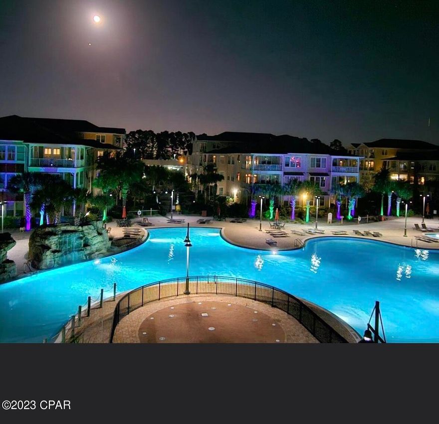 FURNISHED & MOVE N READY OVERLOOKING picturesque waterfalls and the acre island style pool in the serene gated community of Island Reserve. One of a very few PRIME LOCATIONS.  This condo is beautifully updated!   It offers a spacious wrap around porch providing scenic views.  Convenient to drive up to the third floor of your condo.  Elevators in all buildings for easy access to the amenities.  The residence comprises three bedrooms with a privately situated guest suite.  Master bedroom with pool views and door to porch access.   Kitchen also has door to porch access.  Recently updated with new paint, backsplash, pull out wooden drawers in kitchen, new SS appliances, remote controlled curtains in master bedroom, ceiling fan installed in master bath, plush carpet in all bedrooms, mirrors tastefully accented with wooden frames, and so much more!  Granite counters throughout, under counter lighting in kitchen and spacious living/dining combo complemented by an island bar,  New kitchen sink & hardware.  The community offers an array of amenities to enjoy such as pickle ball, basketball, full gym, game room, & theater room. Residents can also look forward to annual dinners and parties fostering a strong sense of community. Don't miss the opportunity to make this exquisite property your permanent home or perfect vacation home.   Approximately 2 miles or less to the white sandy beaches.  NO SHORT TERM RENTALS.  Long term rentals are 6 months or more.