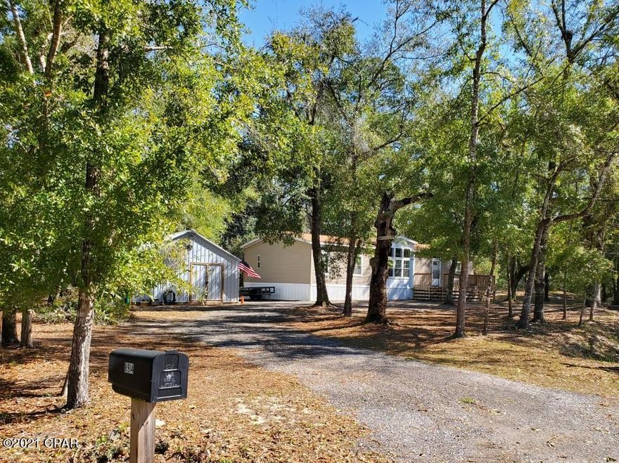 LOCATION!! LOCATION!! A fisherman's paradise near S Burnt Mill Creek boat ramp. Easy access to Pier Park or Lynn Haven just 13 miles away in either direction via 388. Major development in the area by St. Joe and Lattitudes Margaritaville, ensures that this area is poised to become Bay County's newest hot spot for real estate. Located 1.5 miles from the ECP airport allows for easy access to travel. Don't miss your opportunity to acquisition a property near the epicenter of all this major new development, which isn't deed restricted nor has HOA fees. 

Home is a 2014 32x56 Skyline Palm Bay manufactured, featuring energy efficient 2x6 exterior wall construction and R30 insulation in ceilings and floors. Solidly built, it sustained absolutely no damage during Hurricane Michael. -	Split 3 bedroom / 2 full bath 
-	Large master bedroom & bath
-	Ceramic tile/fiberglass/porcelain fixtures 
-	11'  vaulted ceilings
-	Carpeted bedrooms with walk in closets 
-	Huge laundry room with sink and plenty of storage
-	Large 16 x 20 workshop with high ceilings and storage loft
-	Deep well with water softener
