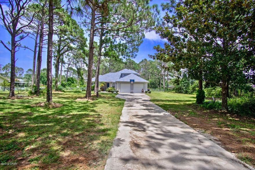 NEW PRICE. Best deal in Panama City Beach if you're wanting quality construction, amazing location and space to play! This 2,400 sq.ft. home sits on a beautiful, almost 2 acre parcel. Not only will you love the privacy and amazing location of this beautiful home, it's also perfect if you want horses, goats and/or parking for your boat or RV. Finding a property like this is very rare and the possibilities are endless! Bring out your inner chef in the spacious eat-in kitchen. Highlights include a gas stove with a hidden range hood, in-cabinet oven, tons of cabinet space, tile back splash, updated stainless steel refrigerator, tile flooring and plenty of counter space for preparing your favorite meal French doors lead into an incredible master suite that features: an over-sized walk in closet, double vanities, a garden tub, plus a separate shower. You'll love the upgraded luxury vinyl plank flooring in the great room and additional bedrooms. A laundry shoot runs from the second floor to the huge laundry room on the first floor. Come spend your evenings relaxing in this Florida room or enjoy hanging out with family and friends in your spacious back yard. This home is a must see! Call to schedule your showing today.