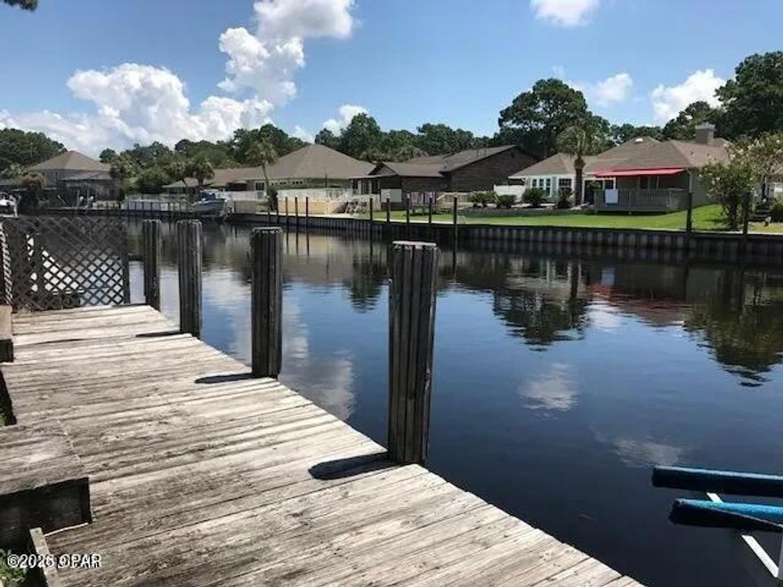 Waterfront Value in Bay Point - A Boater's Dream

Get on the water now with this exceptional opportunity to own a waterfront home in Panama City Beach—one of the area's best buys for coastal living and investment potential. Whether you're looking for a full-time residence or a vacation rental, this canal-front property offers the perfect blend of lifestyle, location, and value. Truly a boater's paradise.

Located in the private, golf-cart-friendly Bay Point community, this home offers both tranquility and an active coastal lifestyle. Bay Point features a Jack Nicklaus-designed golf course, the St. Joe-owned full-service Point South Marina, and a vibrant calendar of year-round community events. Enjoy restaurants and bars within the gated community, optional clubs available to join, including the Bay Point Yacht club, women's club, golf, gaming, wine, and book clubs, and access to the community's printed and online newspaper, BayPointNews.net. The neighborhood is secured with gated entry and 24/7 roving security.

From your own backyard, enjoy a scenic 15-minute boat ride through Bay Point's canal system to the open bay, with Shell Island and the Gulf of America just minutes away.

Inside, the home features an updated kitchen with quartz countertops, soft-close cabinetry, a hidden spice rack, and a double-layer silverware drawer. Additional highlights include two spacious living areas—one with a fireplace—plus a new fence, washer and dryer (2018), and a refrigerator added in 2023.

Step outside to a large patio with a pool overlooking the canal, and a new boat lift capable of accommodating a boat up to 10,000 pounds. This waterfront property offers an outstanding opportunity to enjoy the best of Panama City Beach living—on the water and ready to go.