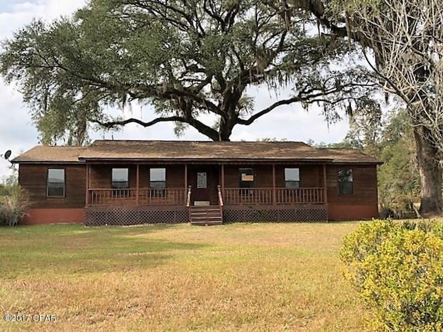 Frame home in the country on 5.4 acres.

There is a detached carport behind the house.  The home has had some updates that include a new roof and some ceiling repairs.  The floors are carpet and tile.  There is a large eat in kitchen that has stove and a dishwasher.  The living room has a fireplace; there is a formal dining room and the bedrooms are all nice size.