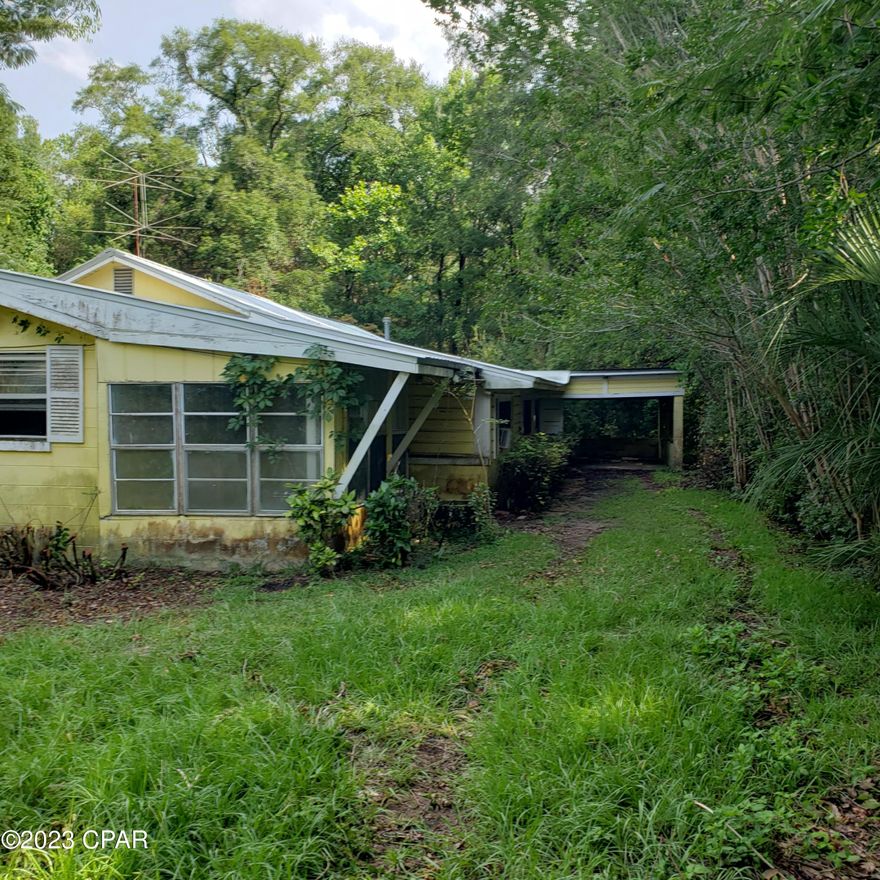 'CURRENTLY UNDER CONTRACT, SELLER WILL CONSIDER BACKUP OFFERS' Huge Price Reduction!!! Older 3 bedroom 2 Bath Concrete Block/Frame Fixer Upper Home. Has a Metal Roof. Has 1601 of living space.  Has front and back screen in porch. Formal dining room, Living room and a den.  One Car Carport. Old storage building is of no value. Cash offers only. Priced to sell. Fix and Save with this large fixer upper. CASH ONLY