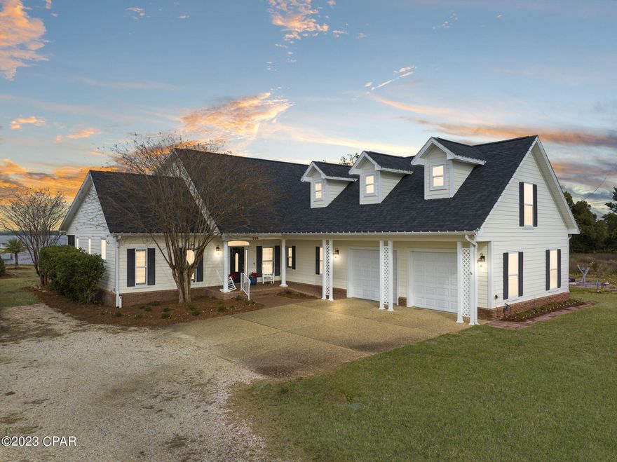 CURRENTLY UNDER CONTRACT, SELLER WILL CONSIDER BACKUP OFFERS**Why the Price Drop?** The sellers are moving, offering you a fantastic deal below market value. Immerse yourself in Bayfront bliss in College Point. This stunning Southern-inspired home offers the ultimate coastal lifestyle, with breathtaking bay views and direct Gulf access. Inside, discover luxuries at every turn, from custom plantation shutters to a cozy fireplace in the expansive living room. The kitchen has brand-new GE Cafe appliances and granite countertops. The primary suite with incredible waterfront views is on the first floor. Upstairs, find privacy in additional bedrooms and a full bath. Outdoors, the shared boat dock, and lift beckon you to explore the Gulf waters right from your doorstep. The home has a brand-new roof, energy-efficient windows, 3-unit HVAC, and more. The oversized garage doubles as a workshop. Close to hospitals, military bases, and white-sand beaches. Don't miss out on this coastal gem - schedule your tour today!