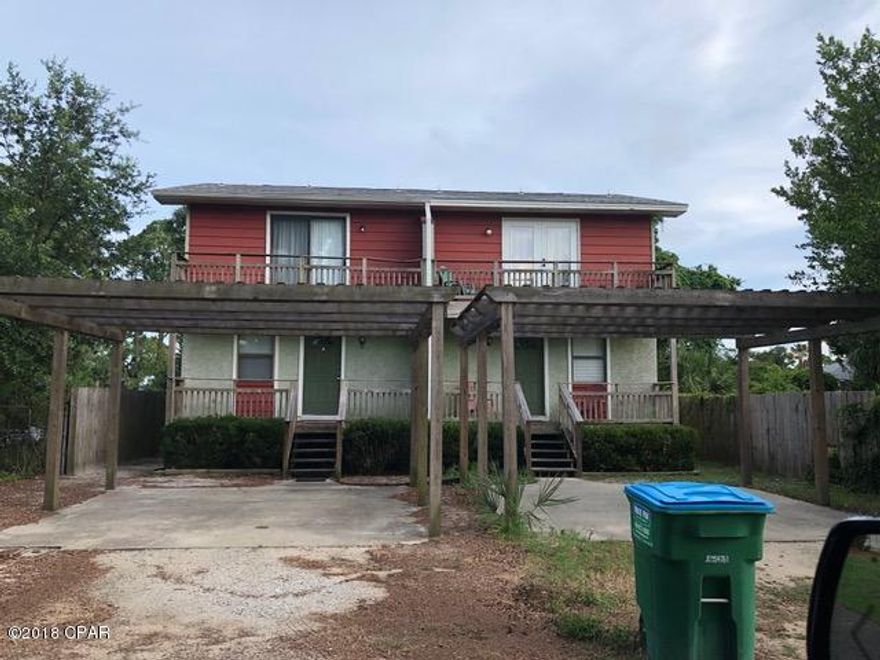 Great 2nd Home or Vacation Rental Property!  Fully furnish townhome ready to move in tucked away across the street from the Lagoon on a dead end street.  The ''A'' unit on the left is the property for sale.  2 bedroom  1.5 baths.  Upstairs bath is Jack and Jill.  1/2 bath downstairs, inside laundry room.  Downstairs entrance is laminate flooring and tile is the rest of the downstairs.  Covered front porch, open deck upstairs off both bedrooms and covered back deck.  There is pergola type covered parking.  Additional storage room off back deck.  An outside shower in the back to wash off the salt & sand from the beach. View of Grand lagoon and just 3 blocks from Gulf of Mexico and boat dock.  Built off grade, by about 3 feet.