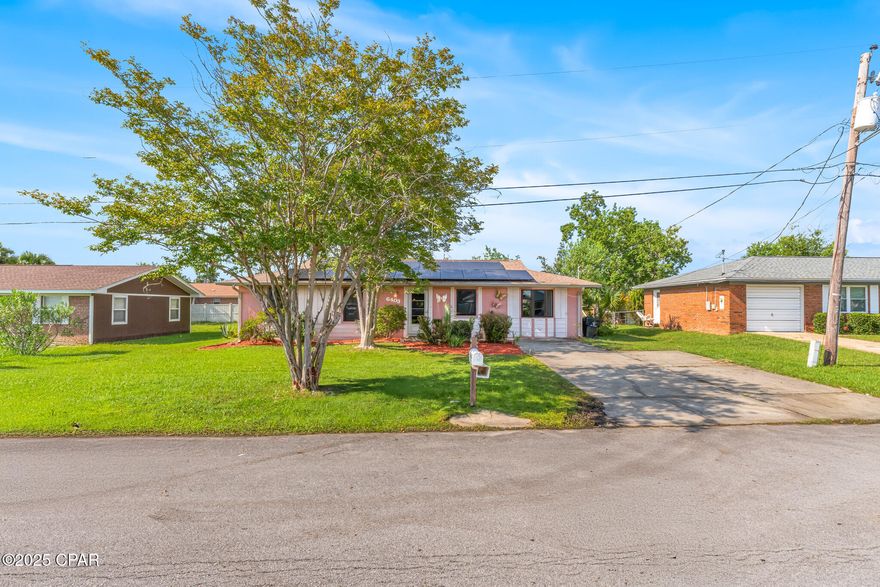 Welcome to your future home conveniently located close to Tyndall Air Force Base. This home features three bedrooms and two full bathrooms, providing ample room for family and guests. The laundry room/utility room is a multipurpose space and offers direct access to the backyard, making it perfect for handling outdoor gear, pet supplies, or gardening tools. For those in need of even more storage, a dedicated storage is accessible from the Florida Room. Use this space for your tools, bikes, holiday decorations, or any items you want to keep handy but out of sight. Experience the best of indoor-outdoor living with the home's screened Florida room. With plenty of room for seating and plants, the Florida room is sure to become a favorite spot for every member of the family. The spacious fully fenced backyard is ideal for pets, play or gardening. The well-maintained landscaping has mature trees and flowering plants. This home is equipped with solar panels, which significantly reduces your monthly energy bills and provides eco-friendly power year-round. The solar system is fully integrated and ready to provide reliable energy for years to come. Located just minutes from Tyndall Air Force Base, this property is ideal for military personnel or anyone who wants quick and easy access to the base. The surrounding area is safe with a family-friendly atmosphere, excellent schools, and convenient access to shopping, dining, and recreation. Beautiful Gulf Coast beaches are a short drive away, as are parks, walking trails, and community centers. If you're searching for a home that offers comfort, energy efficiency, and unbeatable proximity to Tyndall Air Force Base, look no further. Don't miss your opportunity to make this exceptional property your own—schedule a viewing today and discover why this house is the perfect place to call home.