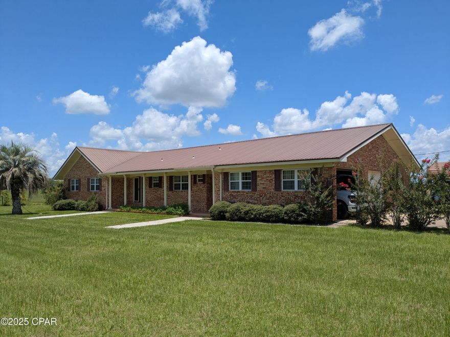 Well built and well maintained brick home on paved rd in Cottondale Fl with 3 Bdrm and 2 full and 1 half baths.
This home has a beautiful setting with a magnificent  view from the 32 by 15 screened back porch of the rolling acres of pasture with beautiful horses grazing. The home has 2,658 of heated a cooled area with a manicured lawn and double garage. Family room has a gas fire place. Also has a  Large living room that also looks out over the rolling pasture, with nice size dining area. Kitchen has custom oak cabinets and granite counter tops.