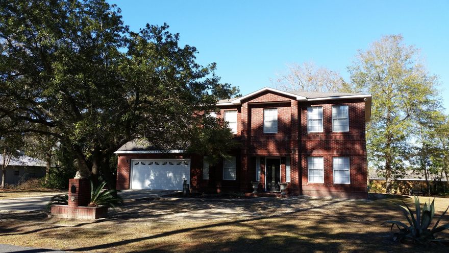 Nice 4 bedroom 3 bath brick home on a 1/2 acre lot. Tile floors downstairs, hardwood upstairs. Separate AC and water heater for upstairs and downstairs. Master bath has garden tub with separate shower and double vanities. Upstairs laundry room (no more carrying clothes downstairs to wash, and back upstairs after clean). Arched entry into kitchen, dining room, and office/sitting room. Sitting room can be converted into a fifth bedroom (downstairs). Two full baths upstairs, one downstairs. Updates include oven, kitchen faucet, and 2nd level HVAC & water heater.  Back porch overlooks the huge back yard. Water views of Mill Bayou from kitchen and upstairs. Burgundy & green rooms will be painted white. Sizes and dimensions are estimates; please verify if important.