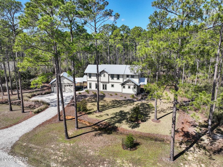 Upscale 2020 construction retreat in the gated waterfront reserve of RiverCamps on Crooked Creek. Enjoy the modern rustic design in this 3 BR/3.5 BA home with 2-car, insulated garage heated and cooled with a mini-split. The first floor has 10' ceilings and includes a guest suite with it's own full bath, a powder room, and large kitchen overlooking an open concept living/dining area. All windows have beautiful window coverings. There is a spacious screened in porch that is perfect for entertaining and an outdoor shower. The 2nd floor has 9' ceilings and includes a master suite, laundry room, loft space, a full bath and an additional bedroom large enough for a king size bed. Notable features include 8' interior and exterior doors, quartz countertops, oak shaker style cabinetry, designer light fixtures, Luxury vinyl plank flooring with carpet in bedrooms, Venetian marble countertops and subway tile in bathrooms. Exterior features include Navajo White Hardie plank lap siding with Timber Bark trim and a metal roof. RiverCamps is a coastal sanctuary designed to embrace the outdoors that is bordered by water on 3sides, the Intracoastal Waterway, Crooked Creek and the spectacular 18,000-acre West Bay. RiverCamps community offers outstanding amenities such as a RiverHouse with swimming pool, and pavilion, a fitness center, 7 miles of trails and boardwalks, and a boat ramp with access to the Gulf of Mexico. Owners enjoy onsite dry-boat storage and day-use boat slips all included in the low HOA fees. All of this located within the gated 1500 acre community of RiverCamps which will have less than 450 homes on 500 acres with the remaining 1000 acres committed to conservation. Call today to schedule your tour. Listing agent is the onsite, community specialist.