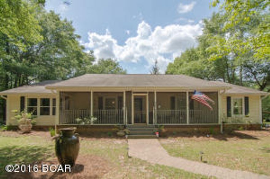 Welcome to your country Oasis. This private retreat sits on 15.5 acres with a beautiful home & separate MIL suite and workshop below. It is convenient to a great school & stores. Secluded, but located near highways, and only 45 minutes to the beach! Pensacola, PC and Destin are all within an hour! Love Scuba? Bring your scuba gear to this country estate, and enjoy three local natural springs. You even have your own spring-tapped well for the home! Hunters will love the Food plot and deer stand. Drive up the long driveway with beautiful, large grassed yard lined with Live Oak trees. Pass through the arbor and in though the screened porch, open the doors to custom, sawmill hardwood floors, walls and ceiling! Unique interiors, tongue and groove walls with a Chip & JoAnna vibe! The well-appointed kitchen adjoining extra large Grand Room immediately captures your attention. The large Kitchen island bar with pendant Mason jar light fixture, covered in custom granite is where cooking for family will be a joy! Stainless appliances, cabinet under-lighting, and accent up-lights create a homey atmosphere. 

Entertain in the large great room, or snuggle together with popcorn and a movie in the adjoining media room (or bonus/craft room). Both the media room and kitchen have exterior exits to the large back deck (LARGE 30'x15')... for grilling, eating and enjoying your serene surroundings. 
All 3 baths are updated. The unique, large guest bath has custom armoire, claw-foot soaking tub with travertine tile surround, and separate shower with same tile; it is like a private retreat all on its own!
An added feature is the 36" halls and interior doors of 36" width, making it wheelchair friendly. 

The master has a double French door (with built in blinds) leading to an additional side deck. 
The master bath has a Jacuzzi soaking tub, walk in closet with built-ins, and a vessel sink on white marble. 

There is a Cypress pond on the property, as well as the Food Plot, Hunting house, chicken coop and storage barn. House comes with an Alliance security system, including a camera and O2 detector. There are 2 septic tanks on the property, with the capacity to add 3 more beds and 1 bath. There is a transferable termite bond with Guardian pest service. This is a MUST SEE if you want a country home with privacy, convenience, beauty and potential to have a fully sustainable home with small farm possibilities, and plenty of room to build more! This is truly a unique place to call home.