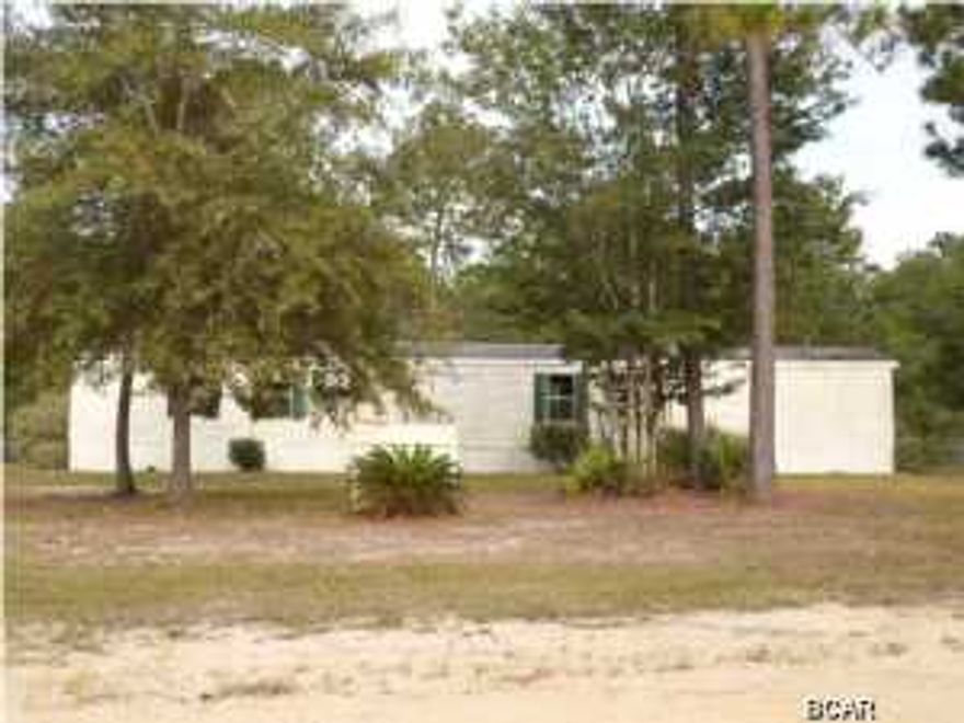 Here's your opportunity to own your own home, with the land, for a fraction of the original cost. This home is very private, located on the Northeast side of Panama City, conveniently located to Deerpoint Lake, for great fishing. The split bedroom plan gives the home a much larger feel and the large master bath has a soaker tub and seperate shower. (All info is approximate, not guaranteed, therefore buyer must verify any and all info that is important.)