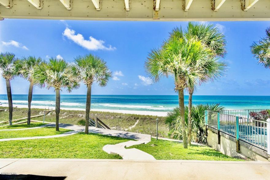 Step right out your door to the gorgeous white sand and emerald waters of the beach! Imagine owning luxurious Panama City Beach oceanfront with your own lawn, sidewalks, palms, and seawall! This unit is light, bright, and beautifully decorated; kitchen has been updated with designer cabinets and corian counters. Watch the gorgeous Gulf of Mexico sunsets from kitchen/ living area and master suite upstairs! It is sold furnished except for some personal items. This three townhome complex has a seawall which is rare.  No association fees as you own your lot. The three units share the cost of common areas. This unit has never been rented. It is across from one of the local's favorite cafes, Sunnyside Grill!  Call for details on buying all three units.