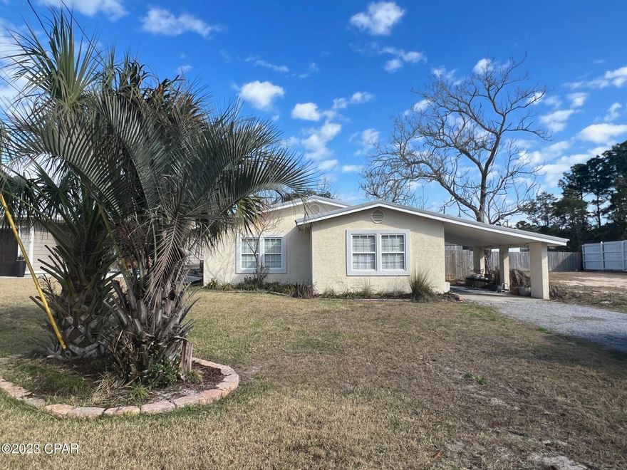 This adorable, cozy beach cottage, located in the coveted west end of Panama City Beach, would make a fantastic first home for a first time home buyer, a vacation rental or a great building lot!  Once entering the home, there is an open living, dining and kitchen area that is inviting and spacious. Great for entertaining! The kitchen boasts newer appliances, the interior has been freshly painted, there is tile flooring throughout and the two nice sized bedrooms are carpeted.  This house has a carport, which can also be used as a seating area for entertaining, the driveway is large enough for four vehicles and all of this is situated on a sizeable lot that is only a few minutes away from the gorgeous beaches and Lake Powell! It's also within a short distance to all conveniences.