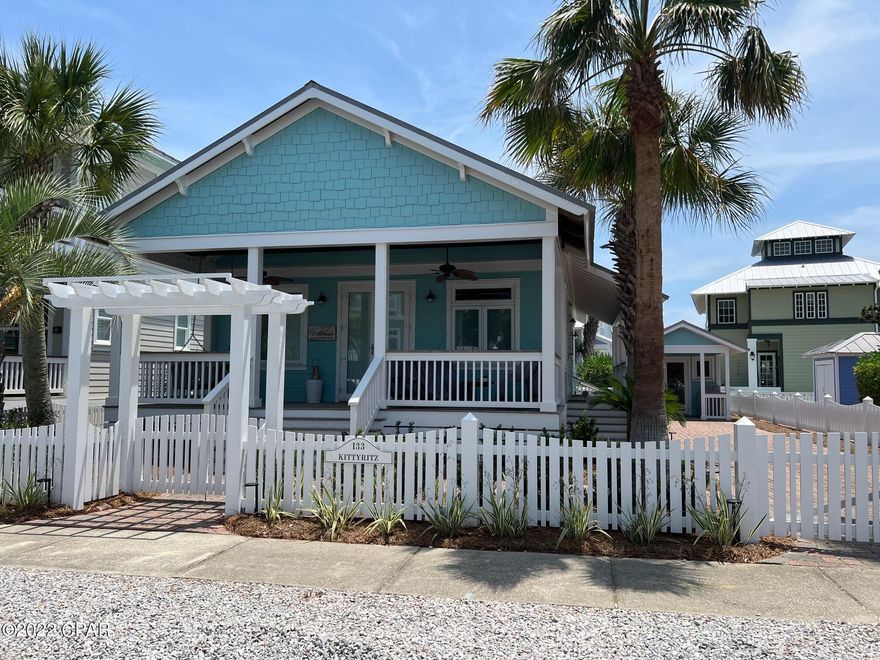 Perfect Old Florida one story beach cottage with 3 bedrooms and 3 baths, hardwood floors throughout and natural stone bathrooms. Desirable wrap around porch on two sides - great for relaxing and visiting with neighbors or just hanging out and doing nothing. Outdoor shower with hot and cold water has a hand wand perfect for coming in from the beach directly into the bathroom - no fuss, no mess.  The ceilings in the vaulted living/dining space are wide cedar plank, all vertical walls are 6'' tongue in grove pine that have the charming ''cottage'' look.  This cottage should not be missed - in the great gated beach community of Carillon - come see it!