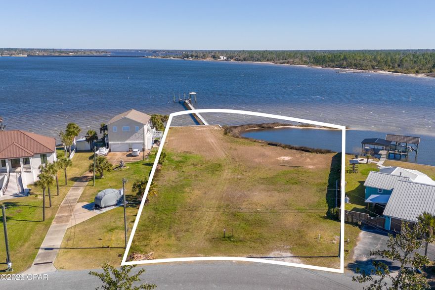 A rare stretch of North Bay shoreline sets the stage for something extraordinary. Spanning 1.2 acres with an impressive 222 feet of deepwater frontage, this offering presents a remarkable canvas for a custom waterfront estate defined by space, privacy and possibility. A solid seawall is already in place, along with a large private dock and boat slips, allowing you to step straight into the bayfront lifestyle from day one. Launch at sunrise, cruise at sunset or simply let the rhythm of the water shape your days. With deepwater access, boating enthusiasts will appreciate the freedom and flexibility this setting affords. What truly distinguishes this property is its own small island feature, creating a natural buffer and a protected cove feel just off your shoreline. The result is a uniquely intimate waterfront experience, where calm waters and wide open bay views exist in perfect balance. It is a setting that feels both expansive and tucked away, offering room to design a legacy home with sweeping outdoor living spaces, a resort-style pool or lush coastal landscaping framed by panoramic water vistas. Located in College Point and near Isaac Bird Park, this homesite pairs serene bayfront living with convenient access to green space and recreation. Properties with this much frontage, acreage and character are increasingly scarce. Here, the foundation for your vision is already in place; all that remains is to bring it to life.