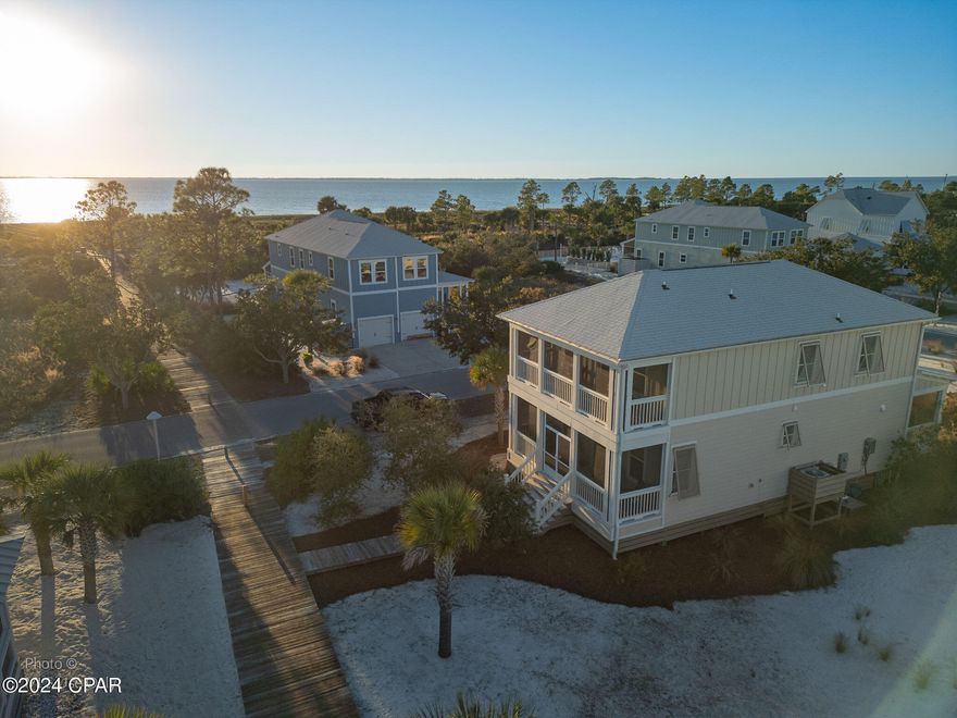 CURRENTLY UNDER CONTRACT, SELLER ACCEPTING BACKUP OFFERS! Great location in Fisherman's Village in Windmark Beach on Boardwalk #3 with great views of the Bay. Beautifully furnished 3 BR/2.5 bath home just a quick walk to the beach for fun in the sun and gorgeous nightly sunsets. Close to Village Center for community pool, restaurants, ice cream, fitness center and wine bar with live entertainment. Dog park nearby also. Home features lots of windows for natural light and views upgraded with Bahama style impact hurricane shutters, and screened porches on front and back. Master Bedroom has a private screened balcony, his and her closets. Upgraded additional features include crown molding throughout, tiled backsplash, and insulated garage with attic access.  Location has access for extra parking for guests. Six seater golf cart negotiable in separate sale. FEMA flood policy is approx. $980/year and can be transferred to the Buyer.  HOA fees are only $490/quarter.