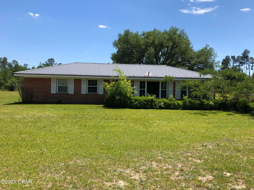 Country home on 4 acres with Hwy 90 frontage. 3/1  brick ranch with parking pad, small fishpond, convenient to I-10, Marianna, Chipley, Dothan Al and Panama City Fl.  Nice yard.  Plenty of room to grow and expand. Home has newer metal roof, updated windows, new well, new septic. Make this your new home.