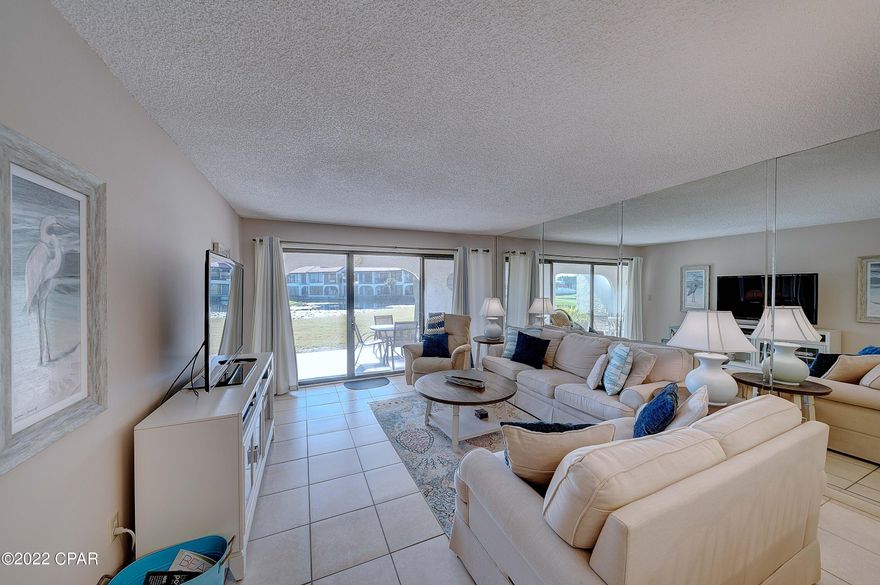 Location location!  Next to heated pool and beach walkover!  Desirable first floor corner unit, no stairs!  This 2 bedroom, 2 bath condo overlooks a pond and has a covered patio to enjoy the Florida sunshine.  Fully furnished with welcoming and serene beach decor, this condo is turnkey - ready for you and your guests to enjoy the beach.  Edgewater Golf Villas are perfect for full time residence, second home, or your investment rental property. You are just steps from the beach, in a gated community, and in one of the most established condos in all of Panama City Beach.  Edgewater Resort offers 12 pools, including the Lagoon Pool, tennis, golf, pickleball, hot tubs, restaurant, coffee and ice cream sundry shop, and more. Walk to restaurants and activates across the street. Call today!