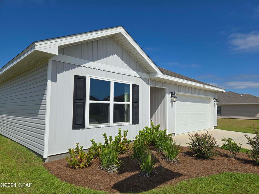 Welcome to Titus Park. This Aldridge floor plan is ready for move in and is located on Lot 54 at 5009 Windrow Way. This home is a model home and any furnishings or window treatments in the home do not convey. If any window hardware is in home, it will convey.  This home features 3-bedrooms, 2 baths, and is approximately 1293 square feet. The primary bedroom and bathroom are located off the entry at the front of the home. The primary bathroom has double sink vanity, large shower, and a huge closet. Proceed down the entry hallway passing the laundry area as you enter the kitchen, dining, and family area. The kitchen offers a breakfast bar and has space for bar seating. There is plenty of open space in this home and the interior features include EVP Vinyl flooring, beautiful cabinetry in Ivory tone and durable laminate countertops. The kitchen comes equipped with a stainless appliance package including a smooth top stove, microwave, dishwasher and refrigerator. You will all find convenience and security with your Smart Home system complete with Skybell doorbell and a Quolsys touch panel that can be used to control your lighting, thermostat and even secure your home. Titus Park is in Panama City, Florida and is only minutes away from Tyndall Airforce Base! This large-scale multi-phase community is located off Highway 390 at Highway 231, centrally located for an abundance of shopping, restaurants, and great schools! Beautiful white sands beaches are just a short drive from your doorstep. Access the bay for fun and fishing by use of the public boat ramp only 3 miles away.  There is a new Publix shopping center across the street from the community entrance.  Titus Park highlights some of the most beautiful floorplans, which have amazing features.