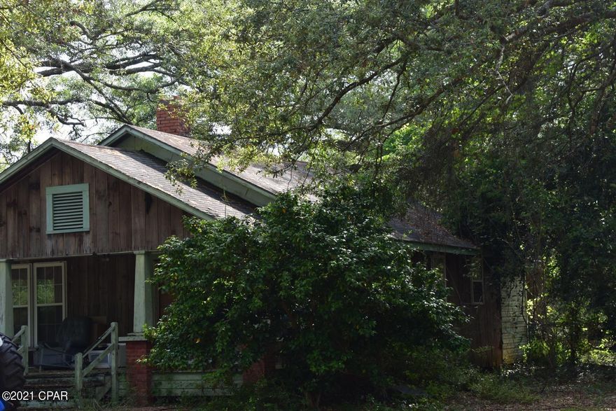 CURRENTLY UNDER CONTRACT, SELLER WILL CONSIDER BACKUP OFFERS. Beautiful 11 + acres with mature trees, including many HUGE granddaddy oaks! This 1940's fixer-upper is an original homestead with a long history in the area, and is in need of repairs to make it a livable space. There are many possibilities with this unique property.  Remodel the existing home, or remove it to build your dream home! Mobile homes are also allowed. Check with the county for possible rezoning to commercial; it has almost 700 feet of highway frontage in a fast growing community! Highway 77 is in the process of being 4-laned. Property is being sold strictly as-is, cash only.