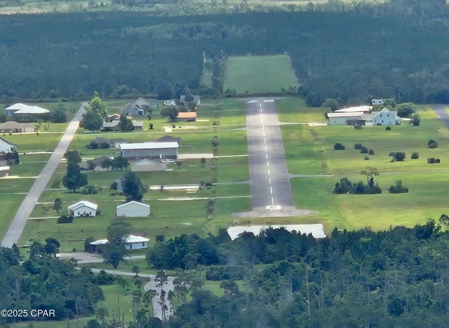Build your dream home on this .75-acre lot in Sandy Creek Airpark (75FL), a exclusive, gated fly-in community in Panama City. This aviation-focused neighborhood spans 18 acres and features a well-maintained asphalt runway (9/27) measuring 3,400' x 60'. Enjoy secure access, peaceful surroundings, and a lifestyle designed for pilots and aviation enthusiasts. The spacious lot is ideal for a custom home and hangar, all just minutes from shopping, dining, and the Gulf Coast's beautiful beaches.