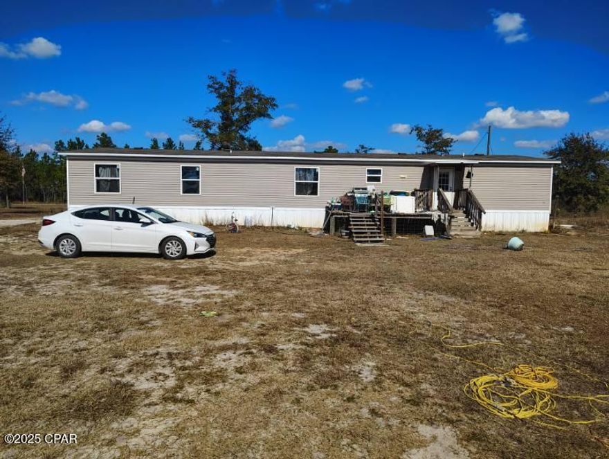 Is there a 4-bed home in Altha with lake access under $200K? Yes, this spacious 4-bed 3-bath retreat offers 2,128 sq ft of indoor living on 5 acres just minutes away from the Lake .
A rare find for nature lovers and weekend seekers alike.

Inside, this 2021-built home delivers a functional split-floor plan with two full living areas ideal for multigenerational living, hosting, or home office setups. The main kitchen includes wood cabinetry, a center island, and open flow into the dining and living space. The primary suite features a large ensuite bath with walk-in closets. Three additional bedrooms offer flexibility for guests, hobbies, or work-from-home needs.

Step outside to a cleared lot surrounded by mature trees and quiet neighborhood. A detached work shed expands your storage or creative space. Enjoy driveway parking, a covered front porch, and a backyard ready for fire pits, gardens, or outdoor play.

Located in Calhoun County near Hwy 274, the home is zoned for Altha schools and about 30 minutes from Marianna. Residents enjoy easy year-round access to Lake McKenzie for fishing, kayaking, and swimming.