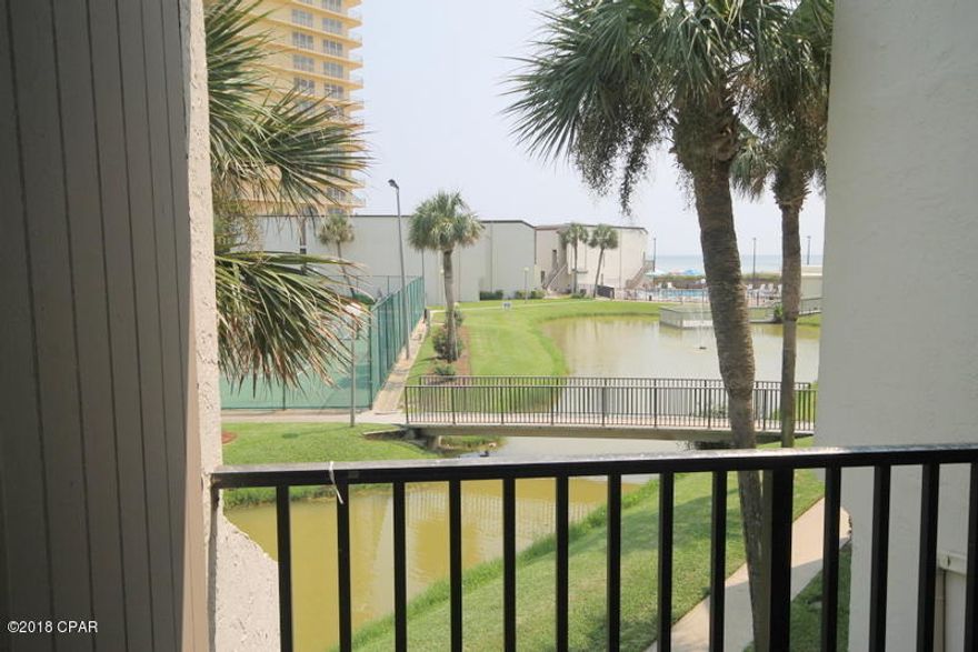 Where can you find a 4 bedroom 3 bath at this price. This unit is move-in and rental ready! Enjoy the view of the freshwater pond, pool and even the Gulf from the first floor balcony off the living area. The kitchen has been updated with granite countertops and stainless steel appliances. The Master Bedroom is on the second floor and has a private balcony with a pretty view of the pond and tennis courts. Lots of closet space inside this condo and there's even a laundry area. Sugar Beach is a gulf front complex with dedicated beach, inground pool, bar-b-q grills and picnic area, community room, tennis courts, and walking paths around the turtle pond. Park right outside your own unit and enjoy all the amenities Sugar Beach has to offer!