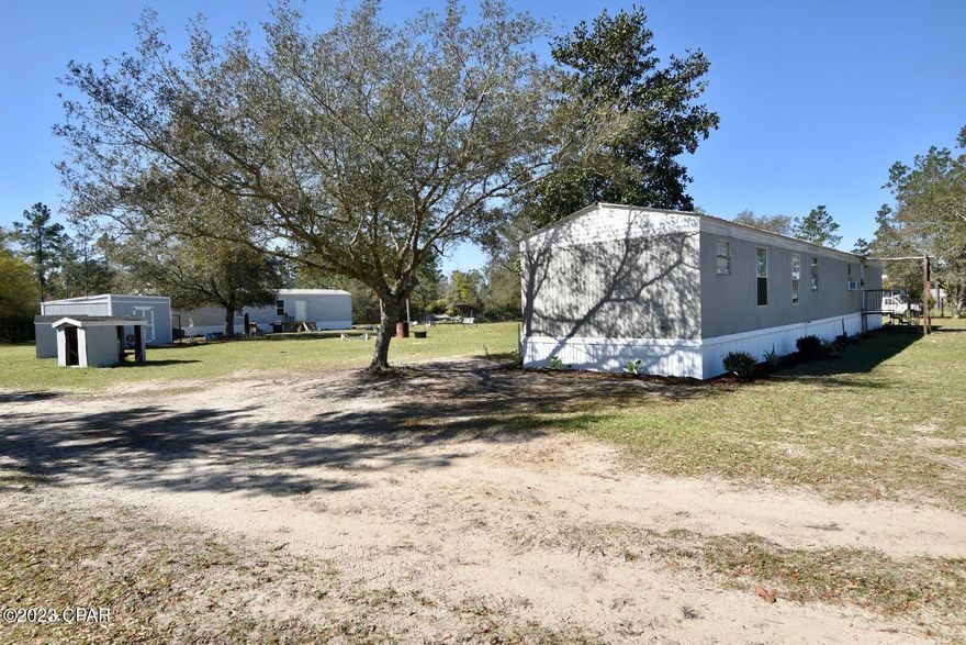 CURRENTLY UNDER CONTRACT, SELLER WILL CONSIDER BACKUP OFFERS
Great opportunity, two single wide mobile homes on 1.4+/- acres. One home is a 2017 3/2 924sq.ft. with new skirting, new deck, new floor covering, paint/wallpaper, new kitchen cabinets, built-in dressers and more! It has central heating/air. The other is a 1987 2/2 1,064 sq.ft. with new skirting, new back porch, new floor covering, some new windows, and newer kitchen. It has a metal roof and window a/c. This one is still in need of some TLC but very livable. Each unit has its own well, septic, and electric pole. Newly built well houses and 12x16 storage shed. The entire property is fenced and gated. Located on a paved road in the country and less than an hour from Panama City Beach this would make the perfect rental investment or multi family property. Cash only!