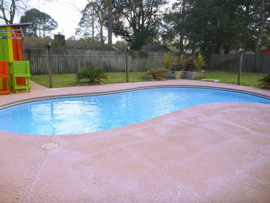 FABULOUS HOME MINUTES TO TYNDALL AFB!  If you like to entertain, this is the perfect house! The pool and deck have been resurfaced and has a little bar that will have you thinking you are in the BVI!! Pool also has a LED color changing light that adds ambiance to your evening pool parties! The garage has been converted to large party room that looks like it is right out of the Caribbean, complete with hanging rataan chairs, a bar, side by side refrigerator with ice maker and room for a dance floor or pool table! The Florida room is bright and inviting with new windows and a/c...the perfect place to begin the day with a cup of coffee or wind down at the end of the day! This home has been completely remodeled! You will love the new bamboo flooring in the foyer, LR and hallway. The kit has lots of new cabinets, granite counters, breakfast bar, tile backsplash, stainless French door refrigerator, built-in dish storage with deep drawers and new slate tile flooring that goes in to the formal dining area. Home has many new upgrades that include doors, deep baseboards, fresh paint inside and outside, carpet, pool pump and filter. The bathroom vanities have been freshly painted and have new hardware. The living room has a stone, woodburning fireplace with a flat screen TV above it that conveys and this room easily holds a large couch. The MBR will fit a king size bed with night stands. The MBA has a tiled shower and a walk-in closet. Both bathrooms have a skylight to add natural light. 2nd and 3rd bedrooms have good size closets. There is also a 12x24 airconditioned workshop, plus storage bldg on the property. Home also has a security system and shallow well for watering the lawn. Age, room size, sq ft, lot size are all estimates. Please measure if concerned.