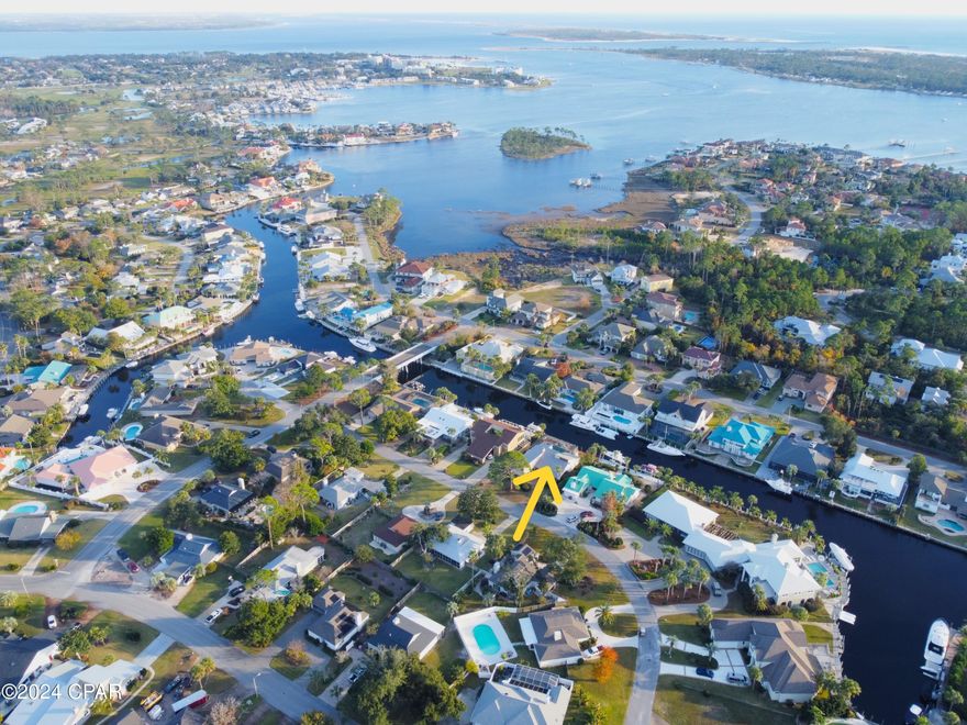 CURRENTLY UNDER CONTRACT, SELLER WILL CONSIDER BACKUP OFFERS'>>>>  BAY POINT CANAL HOME W/ POOL.  Best value on the canal >> JUST REDUCED $10K>>  80ft on the canal.  10 min to the Gulf.  Come enjoy the resort life in Bay Point.  Open floorplan.  Views of the pool and canal from all living areas & the master.  Breakfast nook AND dining area.  Nice cabinets and granite in kitchen.  Huge island.  Double-sided fireplace viewable from the LR & DR.  Laundry off kitchen.  Separate entry to kitchen from carport.  So easy to carry in those groceries.  Huge master with tall ceilings, huge walk-in closet, double vanity, tub & sep shower.  On the other side of the home, two large guest rooms each w/ large walk-in closets.  Inground pool w/ enclosure & whirlpool spa.  Dock has 2 new pilings and new elec.  New roof 2021.  New siding 2023.  Bay Point known for its Jack Nickolas Golf Course, brand new marina, resort hotel w/ restaurants on-site, 24x7 staffed security in a gated community.  Lots of activities and clubs.  You will LOVE this neighborhood.