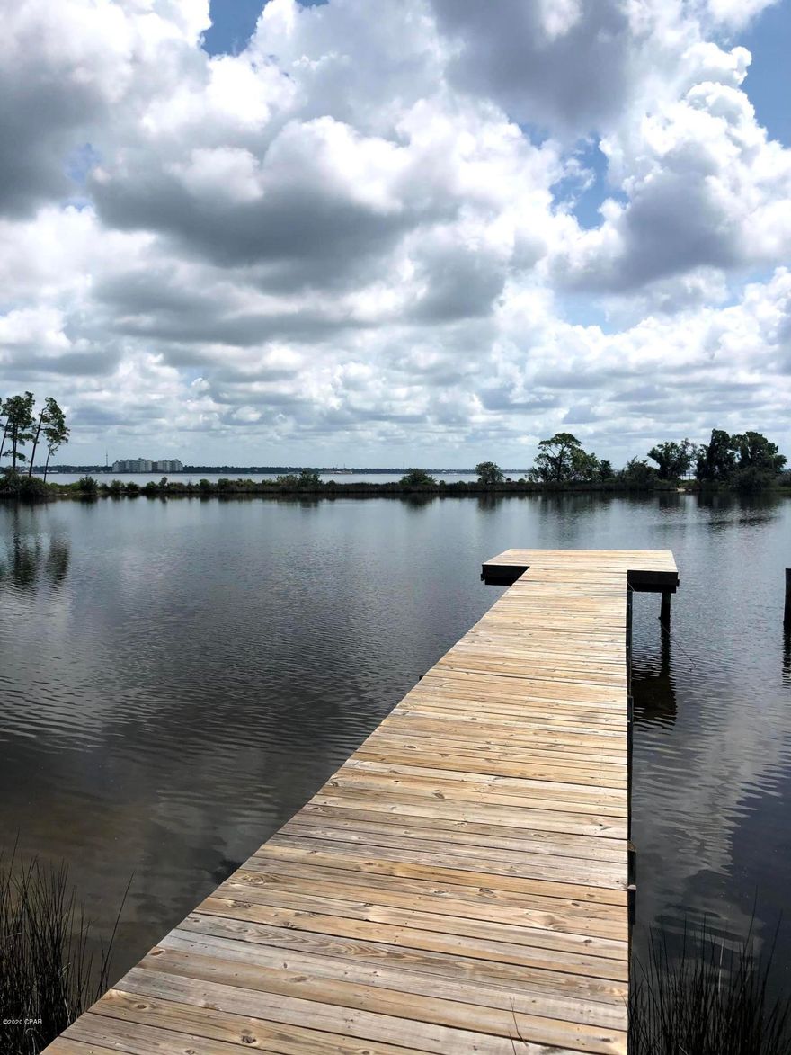 Nice waterfront lot at the end of Magnolia Beach Road.  The lot is close to 1/2 acre, actually .44 acre to be presise.  The shaded lots sits on a small bayou to opens up into St. Andrews Bay.  Water depth off the end of the dock appears to be 5-6 foot deep.  Enjoy the bayou view and if you build a 2-story home then you will also have open bay views.  This lot is very convenient to schools, grocery stores and the Nicholas Golf Course at Baypoint.  You can take your golf cart to the golf course or Publix and WinDixie Grocery stores.  This quiet sheltered bayou offers the boat owner a protected anchorage and peaceful waterfront living.  Take your builder by and show him this lot.