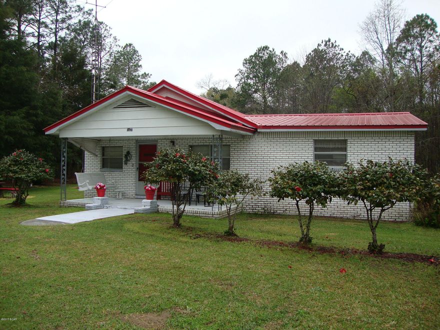 Nice older 3 Bedroom 2 Bath Brick home on 1+ Acres. Has large L-Shaped living Room with fireplace. Country kitchen with breakfast bar, nice size dining room and a bonus room could be 4th bedroom. Has electric central heat and air system plus gas wall heater in all rooms for extra heat. All appliances stay to include Gas stove.  Metal Roof. Large storage/Utility Building. Nice deck across the back. Beautiful landscaped yards with gazebo and concrete picnic table and chairs. Great country living with paved road frontage.