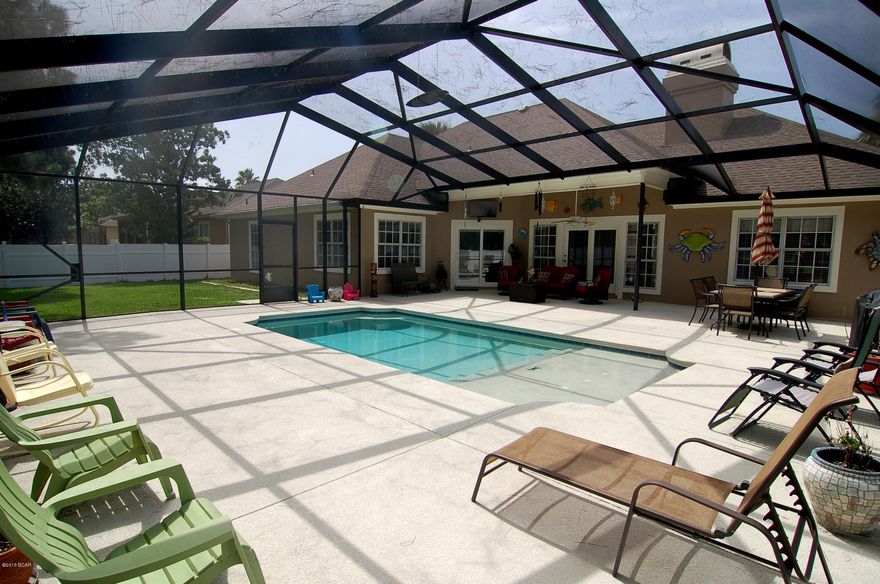 This beautiful Glades home on the Hombre Golf Course is now vacant. The sun-drenched ambiance flows through the front rooms of this home. You want a home that shows pride of ownership then look no further. She added a screened in heated oxygenated chlorine swimming pool and a patio that measures 44' X 39'. For privacy, you have a new vinyl 6'fence around all of the back yard. The interior and exterior have been freshly painted. The garage has a new golf cart side entry. The garage is over sized (22.2 X 21.10)and has two 9'wide garage doors. This home has all new white washed tile that looks like wood throughout the home. Kitchen has all new appliances and a new glass backsplash. Also new are the gas fire place logs, ceiling fans counter tops and sink. Plenty of storage space. Low HOA fees. In the kitchen you have all new cabinetry and hardware. The counters are Corian and all your new appliances are GE. The expansive master bedroom has a sitting area that looks out to the pool. The master bedroom closet is huge measuring 12 X 9.  You will love that feature.