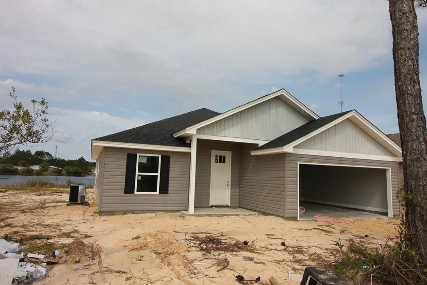 Cozy lake front home in a great community. This is a new construction home with custom cabinets, Granite counter tops, open spacious floor plan and is convenient to town and Tyndall AFB. The property sits on a pond.