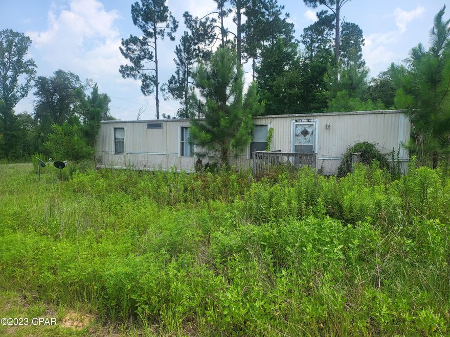 This beautiful property is seven acres with an older MH, two septics, a well, two light poles with electric, and over 300 feet waterfront on the Race Pond in Sneads Florida. It is ready for your new home or MH or two. There is an older MH the front two acres of the property. It is in need of some work but could be occupied while building or a rental for additional income. The back five acres is waterfront. This property is a short drive to Sneads, Marianna, and Lake Seminole. It is the perfect location for peace, privacy, and would be a fisherman's dream property. High and dry property in X flood zone, flood insurance NOT required.

Parcel ID for the back 5 acres of vacant land:  01-4N-08-0000-0150-0020