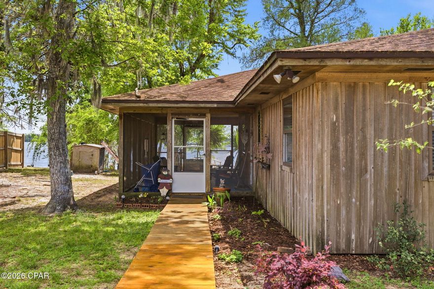 LAKEFRONT Living on Deer Point Lake! Welcome to 4344 Huckleberry Lane, a hidden gem nestled on the pristine shores of Deer Point Lake in Southport, Florida. This beautiful waterfront property offers the perfect blend of serenity, space, and stunning views--ideal for outdoor lovers, fishing enthusiasts, and anyone craving a peaceful retreat. Enjoy direct access to the lake from your own backyard, where you can fish, kayak, or watch the sunset over the water. Whether you're seeking a full-time residence or a weekend getaway, this home offers a rare opportunity to live on one of Bay County's most desirable freshwater lakes. This charming 2-bedroom, 1-bathroom lakefront home is thoughtfully designed for comfort, accessibility, and relaxation. With ADA-friendly features like wider doorways to accommodate a wheelchair, it's ideal for anyone who values ease of movement without sacrificing style. Step inside to an open concept living space, where the kitchen takes center stage with a central island and breakfast bar, durable cabinetry, and plenty of storage. The south-facing wall is lined with windows that flood the home with natural light and offer panoramic views of Deer Point Lake, bringing the outdoors in, every day. A spacious utility room allows for either a side-by-side or stackable washer and dryer setup, adding functionality to your everyday routine. Just off the main living area, you'll find a large screened-in patio--perfect for sipping coffee, watching the wildlife, or unwinding with a book in the breeze. The home's rough-cut cedar siding is both beautiful and durable--well-suited for Florida's rugged climate. Whether you're searching for a full-time residence or a peaceful retreat, this lakefront gem delivers accessibility, character, and unbeatable views. This tight knit community has no HOA fee, and your lender will not require you to carry flood insurance as this home sits higher than the AE flood zone. This community features underground utilities, city water and city sewer is binging installed in the community. This home also has an irrigation well for watering your plants or anything else you would like to do. The HVAC system is only a few years old and the roof on the home was replaced in 2019 Call for a showing today.