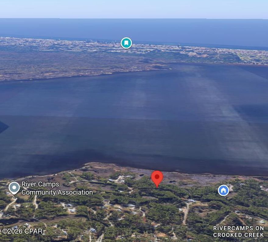 One-acre, unobstructed bay view Lot in the exclusive gated, waterfront community of RiverCamps in Panama City Beach. This Lot is on a paved road and is ready for you to work with an architect/designer and custom builder to build your dream home with no neighbors behind you, ever, to spoil the view or serenity. RiverCamps is a waterfront, nature preserve. 1500 gated acres with less than 450 home sites. 1000 acres are committed to conservation. There are over 7 miles of connected trails and boardwalks ideal for hiking, biking and exploring nature and the abundant wildlife. No buildout time when you buy in RiverCamps, yet you immediately get to enjoy the community boat ramp that will have you at Shell Island and the Gulf in 30 minutes, dry-boat storage, day-use boat slips and unlimited use of kayaks and canoes. New fitness center construction is underway and the new pool and pavilion is open!
Publix Grocery has broken ground just 2 miles from RiverCamps and there will be 450,000 sq. ft. of adjacent retail space. RiverCamps is close to everything yet a world away from the traffic and the crowds.