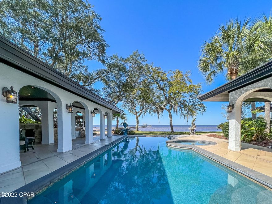 If luxury and relaxation on the water is what you seek, look no further! Approaching this Mediterranean inspired estate, you'll notice pristine landscaping to include fruit trees and camellias, a fenced in courtyard, concrete pool and hot tub, full outdoor kitchen, and multiple arched breezeways surrounding the home. Inside this grand home, we have an exquisite kitchen with Viking appliances to include an oversized refrigerator, 6 burner gas stove and griddle, double ovens, ice maker, dishwasher, and a built in Miele/cappuccino maker. We also have an array of cabinetry for storage with under cabinet lighting. Entering the living area, you will notice the gleaming walnut flooring and expansive space ideal for entertaining. See additional remarks for more! This living area is surrounded by windows for natural lighting, features a Grand Piano which conveys with the home, has an oversized gas fireplace, dining area, and a bar for serving guests. On the opposite side of the home, we have our bedrooms and attached 2 story casita home ideal for in laws or guests. Our large main suite features a fireplace, his and her bathrooms with walk in closets, and 4 sliding glass doors which open up to the pool and patio areas. Surrounding the pool outside, we have our gorgeous pavers, patio space, fire pit, and 500 foot dock with observation deck, boat lift, and pontoon lift. Our attached oversized 3 bay garage is heated and cooled and serves as entertainment space, workshop, and more! Roof is new March 2022 and 4 AC units are new 2019. This home is also equipped with a whole home generator and artisan well. This truly is an incredible opportunity! Furnishings negotiable except owner's primary suite furniture. Measurements approximate. Buyer to verify if important.