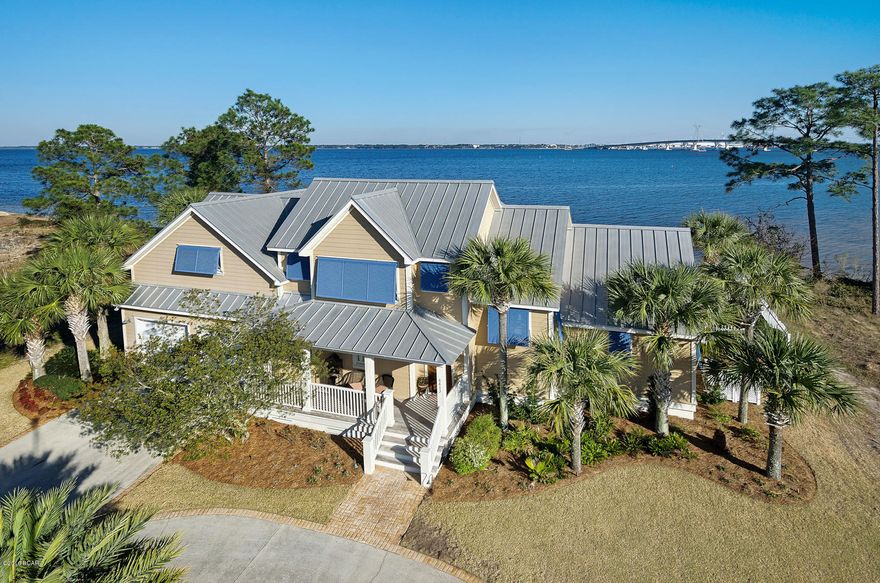 Gorgeous home right on the bay! This custom built 4 bedroom home features a waterfront pool with sundeck, outdoor kitchen, oversized garage, and all the upgrades you can imagine, complete with boat slip in the community Marina for a boat up to 40 ft.  The interior is well cared for and boasts heart of pine floors, solid wood doors, silestone countertops, Viking 6 burner gas stove and double ovens, sub zero refrigerator, Andersen windows and doors, and Bose home theater surround sound. Enjoy outdoor living with huge screened in porch with Ipe floors (Brazilian hardwood), waterfront saltwater pool with oversized pavered patio, beautiful landscaping, outdoor shower, outdoor kitchen with Viking hood, your own dock, and best of all - fabulous views! This home is the perfect home and boasts quality construction inside and out, that will provide a lifestyle that is both relaxing and entertaining, and allows you to enjoy life on the Bay.  Dolphin Bay is a gated waterfront community with tennis courts and marina.  Excellent location close to Navy base, Pier Park, beaches, and all Panama City Beach has to offer!  Call today to see this gorgeous property! Easy to​​‌​​​​‌​‌​​​​‌​​‌​​​​‌‌ show!