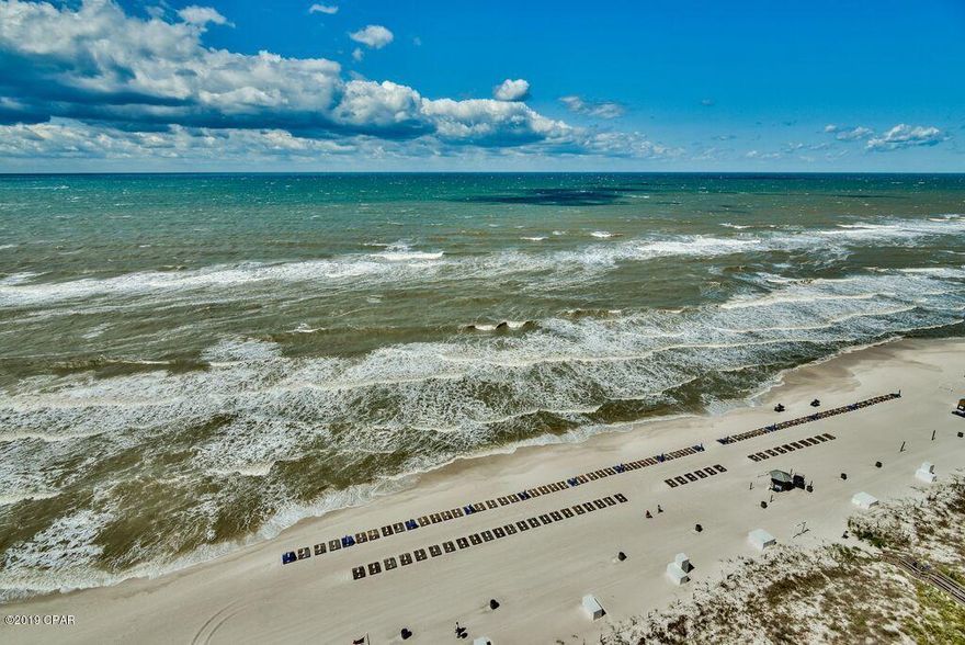 You'll love this totally redone oceanfront 2-bed condo with bunks at Emerald Beach Resort! A LOT OF NEW:  Paint, Appliances, Furniture, Curtains, Smart TVs. Water Heater 2019, AC 2015.  Pet friendly for owners. This beautifully spacious floor plan includes a beachside master with bay window and en suite bath. The large balcony promises summer breezes, sounds of the surf and sunsets. The furnishings and decor are of tasteful quality which is apparent throughout ... Crown molding, tile in the living areas and carpet in the bedrooms. The pretty kitchen features upgrades you would expect in a distinctive property. In-room stackable laundry. The second bedroom, bunk beds and sofa sleeper make for good rental income to offset ownership expenses. Click ''More'' to view EXCLUSIVE RESORT AMENITIES EXCLUSIVE RESORT AMENITIES:  Emerald Beach is an upscale seaside resort and a fun place for families with children, happy couples or anyone looking for a get-a-way. Relax at the beachside pool with hot tub, tiki bar and boardwalk access to the stunning beach. There are two children's pools with water features, snack bar, shuffleboard, corn hole, free game room and activities center. The incomparable SkyBar hosts Happy Hour and fun events with a Starbucks and Gift Shop just down the escalator. Everyone loves the Food Stand with pizza, hamburgers, ice cream and board game table! Stay swimsuit ready at the Fitness Center with Day Spa. The BBQ area with picnic tables is perfect for a traditional summer's day. There is an attached gated garage with elevators and street walkover to the main resort. Centrally located with FunLand Arcade and a small retail center across the street. You can walk to beachfront Runaway Island Restaurant. About a mile from Pier Park's shopping, dining, entertainment, dog beach, fishing pier and concert venue. Emerald Beach Resort is one of the most sought after complexes on the Gulf of Mexico.