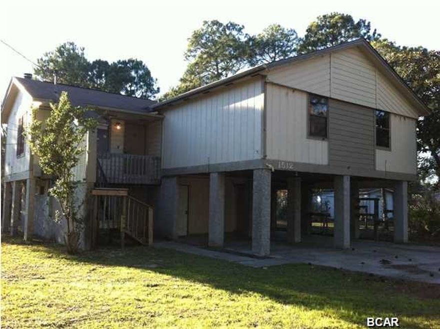 Located near Tyndall Air Force base, this home sits an 1.5 lots and overlooks East Bay. Sit on the huge screened porch and watch the sunset or just watch it while you're in the kitchen cooking dinner. The main living area is on the second floor so the views are great. The living room has a fireplace and high ceilings. The kitchen is open to the living room. Also on this level is the master bedroom with bathroom en suite and two other bedrooms and another bath. The first level has two huge rooms and a bathroom. This is where all the options come in! The whole lower level is not included in the square footage but has window units. Both rooms have closets. One room is especially large and has a door to the back yard. This room could be a family room, a game room, or the whole lower