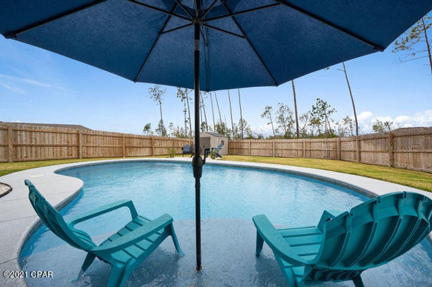 This almost new home is a GEM! Quality finishes, a back yard oasis, central Lynn Haven area and located near top rated schools! The floor plan is open, bright, and inviting. The oversized island is a great space for the chef to work and the custom cabinetry, granite countertops, stainless appliances and pantry add to the quality! The master bedroom overlooks the inviting backyard and includes a walk-in closet. The en suite bath has double vanities, a relaxing garden tub and a separate water closet for privacy. While the two extra bedrooms downstairs are of good size, the upstairs 4th bedroom/bonus room has a full bathroom and is the perfect man cave, guest room or teen retreat! But let's be honest...we want to know more about that back yard! The sparkling pool with sundeck and the covered patio with TV will be ideal for those relaxing days in the sun.  A line of trees stands between you and the neighbor behind you which allows for more privacy! Camryn's Crossing is a great neighborhood with sidewalks, a playground and no through traffic.  Seller is offering a one-year home warranty for buyers' piece of mind. All measurements approximate, buyer to verify if important.