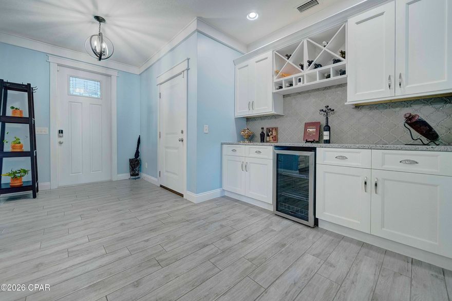 Discover 223 Wiregrass Lane in Ocean Mist, a secluded, gated beach community with just 24 craftsman-style homes, sidewalks for strolls, and underground utilities adding a special touch. This home sits at the end of a tranquil cul-de-sac beside the community pool, offering both privacy and easy access to the Gulf, only half a mile away.
This custom-built home features 4 bedrooms and 3.5 bathrooms, designed with numerous upgrades, and is the only one of its kind in the community. Step inside to find elegant porcelain wood plank tile flooring leading into an open-plan living area. The kitchen includes a spacious island with breakfast bar, walk-in pantry, glass cooktop with stainless range hood and pot filler, granite countertops, soft-close cabinets, high-end appliances, built-in wine bar with refrigerator, and a formal dining room. The kitchen seamlessly connects to the living area and extends to a covered patio and private backyard. The master suite, located downstairs, opens onto the patio through double doors and features a walk-in custom tile shower, free-standing tub, dual vanities, and a walk-in closet with custom shelving. A convenient laundry room is also on the main level. Upstairs, you'll find a second ensuite bedroom with vanity, shower-tub combo, and walk-in closet, plus two additional bedrooms, each with walk-in closets and a guest bathroom.
The must see two-car garage features, epoxy-coated floors and customized storage for outdoor enthusiasts. Raised garden beds along the side of the house are ideal for organic gardening. Additional upgrades include two HVAC units, programmable thermostats, ADT alarm system, sprinkler system, rain gutters, hurricane shutters, crown molding, plantation shutters, and stylish window treatments throughout. The home can be sold partially furnished or with the golf cart dependent on offer.
Enjoy entertaining or relaxing in these bright spaces, or take advantage of community amenities. The property is conveniently located close to the beach--walk or ride your golf cart--and only minutes from Pier Park, popular restaurants, golf courses, and shopping destinations. Quarterly HOA dues cover weekly trash pickup and access to the pool, pergola, and bathhouse. Don't miss your opportunity to own this beautiful beach home--schedule a tour today! While all information is deemed accurate, buyers should verify details if they are of importance.