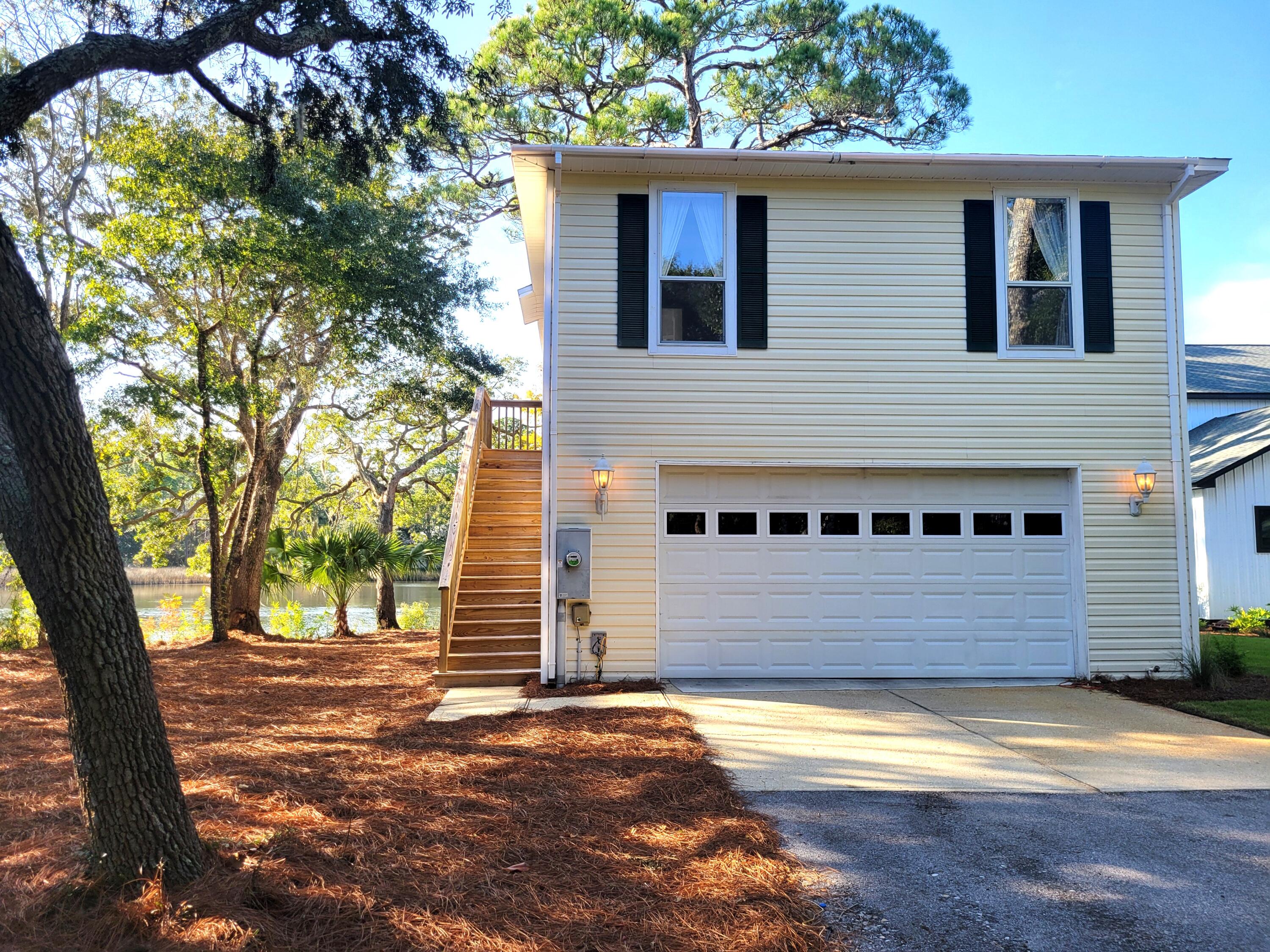 Cozy and quiet waterfront home nestled on the majestic Mussett Bayou complete with your own boat slip. Upstairs features a huge bedroom and full bath, an open kitchen and living area with fantastic views of the water from inside or the outside deck. The downstairs area also has a porch with a swing and water view. The inside was a former workshop. It has a half bath, work bench and ample storage cabinets and shelves and still room for cars. Roof was replaced 1/2022.