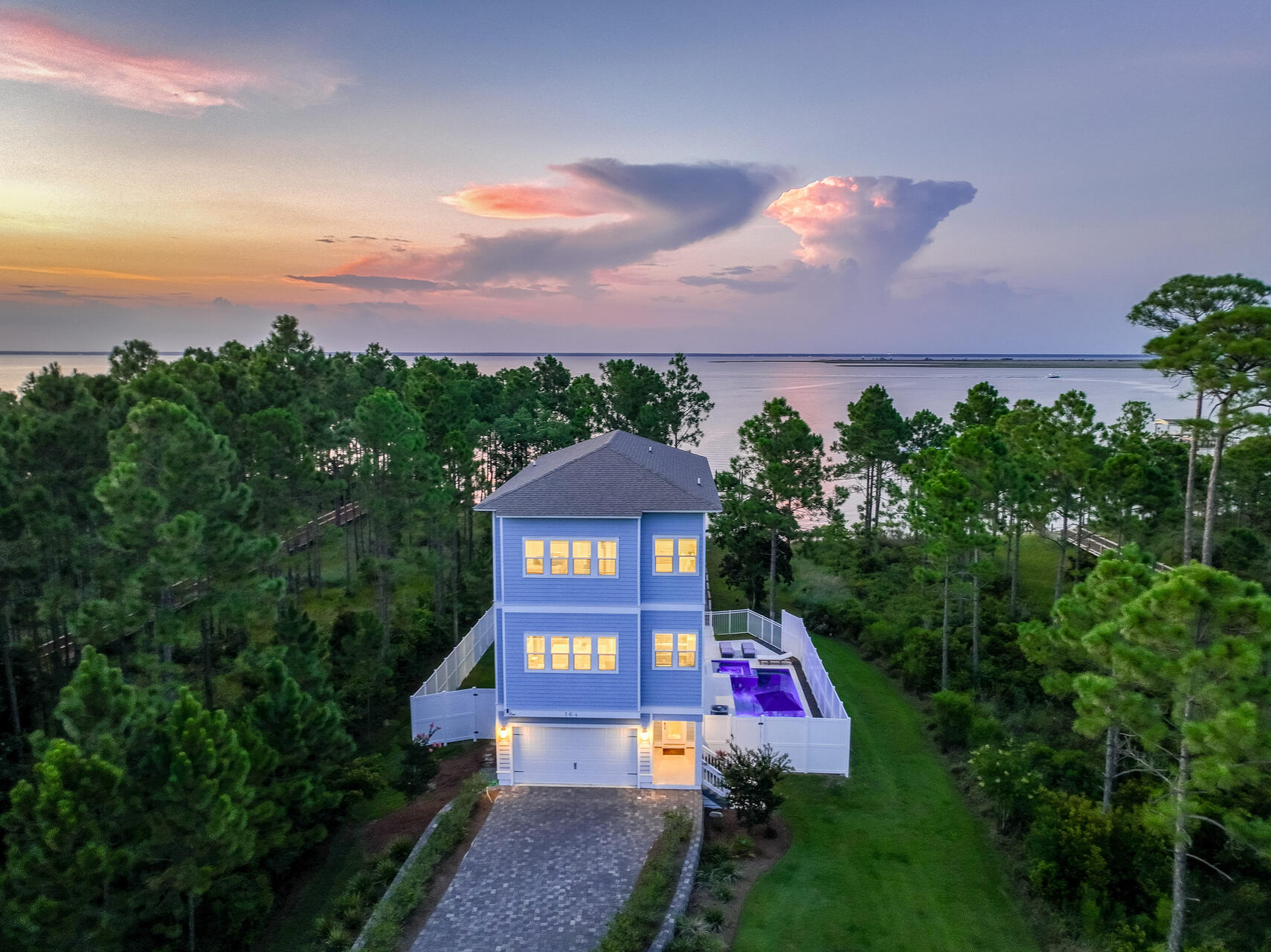 Experience unparalleled luxury at 164 Kali Lane, a recently built waterfront home on Choctawhatchee Bay. This exquisite 4-bedroom, 3.5-bath residence spans three levels and features a private elevator for convenience. The open floor plan boasts high ceilings and includes two primary suites, each offering breathtaking bay views. Outside, enjoy your own private oasis with a sparkling pool, expansive deck, and a private dock with a boat lift. Set on over an acre in a prestigious gated community, this home combines elegance and privacy. Nestled in Santa Rosa Beach, just minutes from white sand beaches, world class dining, and elegant shops, this location provides the best South Walton. Don't miss your chance to own this slice of paradise--contact us today for a private showing!