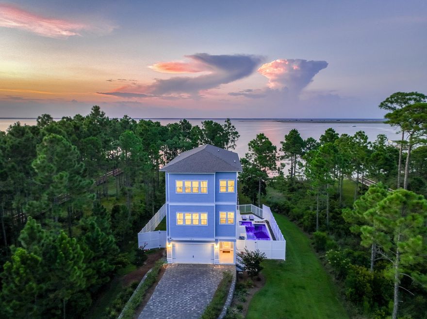 Experience unparalleled luxury at 164 Kali Lane, a recently built waterfront home on Choctawhatchee Bay. This exquisite 4-bedroom, 3.5-bath residence spans three levels and features a private elevator for convenience. The open floor plan boasts high ceilings and includes two primary suites, each offering breathtaking bay views. Outside, enjoy your own private oasis with a sparkling pool, expansive deck, and a private dock with a boat lift. Set on over an acre in a prestigious gated community, this home combines elegance and privacy. Nestled in Santa Rosa Beach, just minutes from white sand beaches, world class dining, and elegant shops, this location provides the best South Walton. Don't miss your chance to own this slice of paradise--contact us today for a private showing!