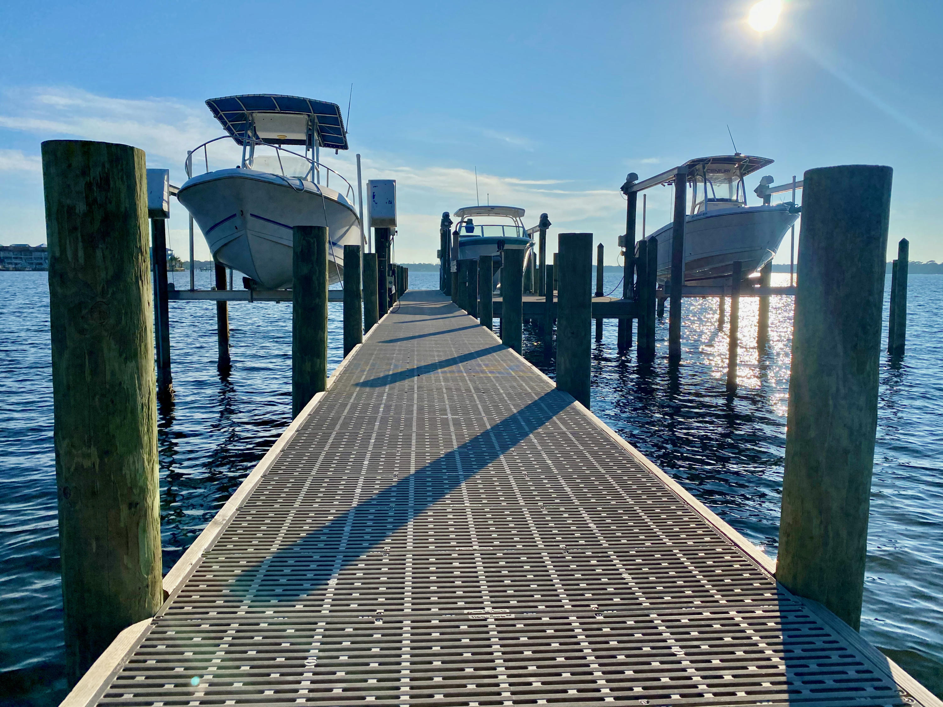 Boater's Paradise Found! NO HOA! Only a short 5 MINUTE boat ride to Crab Island and The Gulf restaurant. Marina/Fuel Dock next door! 3 year old almost 50K dock with high end Flow-Thru decking. Items replaced/added were pilings, boat lift with remote control, custom built fish cleaning table, solid sea wall with additional rip-rip added, and a swim/yolo/kayak deck. Large boats welcome! Seller states 16 ft depth at the boat lift. Dock has 3 slips that are owned with 2 other boaters. Watch the sunrise and sunsets, from the 32x10 screened porch area that includes an attached covered porch. Inside the kitchen, you will be delighted with the 12 ft long granite topped kitchen eat-in bar, stainless steel appliances, gas stove for the chef, abundance of new cabinets, pantry, and inset lightin