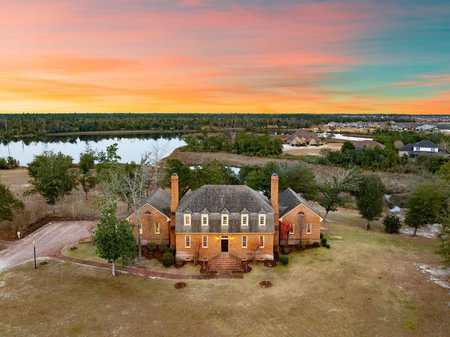 Step back in time to the grandeur of Colonial Virginia with this extraordinary Georgian Manor, inspired by the historic Wythe House where Thomas Jefferson once lived and studied law. Designed by Mark Wenger, chief architect for the Colonial Williamsburg Foundation, this remarkable estate blends timeless architecture with refined craftsmanship. Inside, the impeccable interior showcases four bedrooms, a private study, a basement complete with full gym and game room, and striking architectural millwork throughout. Oversized 9x12 wooden windows with interior shutters, intricate wainscoting, a custom staircase, four fireplaces, and interior archways complement nearly 200-year-old Loblolly pine flooring. Ten-foot ceilings are adorned with antique chandeliers and sconces, creating an atmosphere of classic elegance and warmth. Beyond the ornate gated entrance lies 12 breathtaking acres of a fully functioning equestrian estate nestled among deep oak woods and overlooking 1,200 feet of picturesque Mill Bayou. The exterior features handmade Old Salem brick, a stately front fountain and swan pool, and a Baroque-style manicured lawn. Exact brick replicas of a Williamsburg-style gazebo, complemented by a charming bridle path and a classic smokehouse at the water's edge, further enhance the property's timeless historic appeal. Equestrian enthusiasts will appreciate the exceptional horse facilities, including a 10-stall working barn with office and tack room, dedicated stables, a lighted dressage arena, and a jump course--making this a rare opportunity to own a private, turnkey equestrian farm designed for both beauty and performance. Ideally situated in North Florida and just four short hours from Ocala--known as the ''Horse Capital of the World''--this estate offers convenient access to one of the nation's premier equestrian destinations while maintaining the privacy and serenity of its own waterfront sanctuary. This one-of-a-kind estate offers historic inspiration, waterfront serenity, and premier equestrian functionality in a truly unforgettable setting.