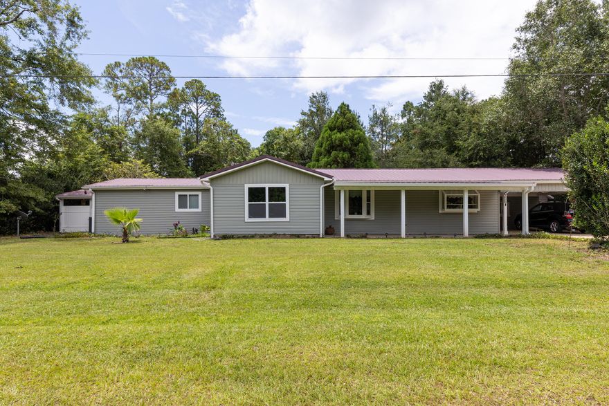 Beautiful 3 bedroom/2 bath home on private 1/2 acre lot in sought after Avalon Beach community. Inside you'll find massive updated kitchen with plentiful cabinets, large center island with bar seating, stainless steel appliances including double oven, dual dishwashers, buffet/coffee bar, pantry, and eat in dining area with hardwood floors (no carpet in home at all!) that lead to living room and light-filled sunroom. Spacious primary suite features sitting area, huge walk in closet, door to back yard and updated en suite bath w/ spa-like custom tile shower w/ bench, secondary bedroom features attached bath w/ large soaking tub and custom tile. Outside--enclosed front porch, fenced back yard with lush landscaping including garden pergolas, covered patio with hot tub, 2 car carport.
