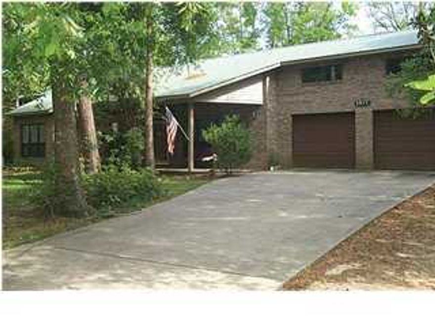 A Wooded Oasis right in the heart of Town! Adams Powell/Bob Sikes Neighborhood - one of the most desirable ''in-town'' locations. Convenient to everything - Children can safely walk to Bob Sikes Elementary. Design of home is Ultra contemporary, with inspiration from a Frank Lloyd Wright design, open and very spacious plan with features such as ceiling heights of from 9 to 11 feet - ceilings in Master Bedroom, Kitchen & Dining v-edge wood paneling, Hardwood floors in Entry, Kitchen and Dining area. Large windows open to views of natural, heavily wooded vegetation of Oak, dogwood,ferns and others, makes you think of the Mountains! MASTER BEDROOM is HUGE! Sitting Areas, LARGE Walk-in Closet; Master Bath has large shower and large whirlpool tub - other TWO baths have 3'X5' cultured
